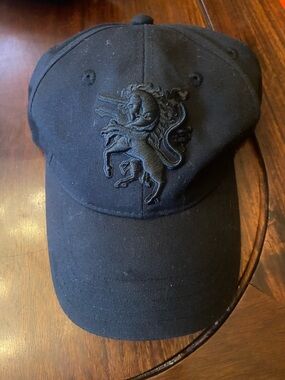 Philip Treacy Black Cap with Purple Label and Gold Text